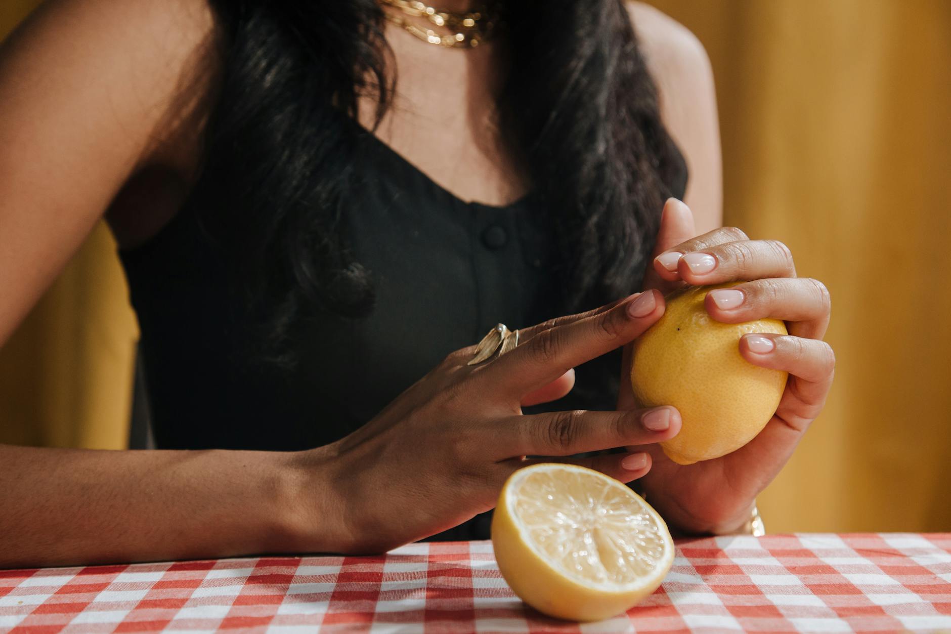 Woman holding silicone vibrators and examining them thoughtfully