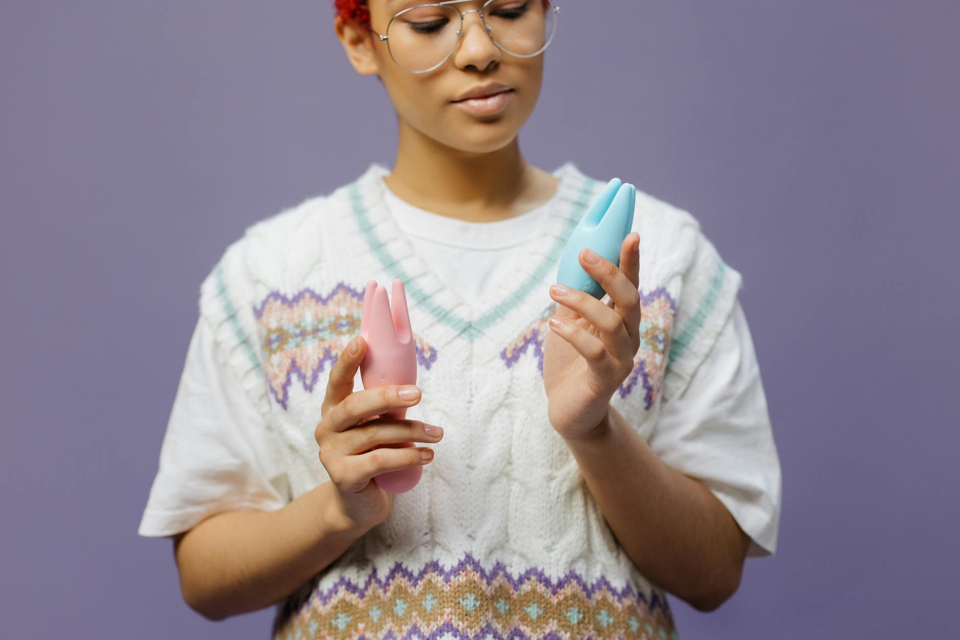 Woman examining a clitoral vibrator with curiosity and confidence